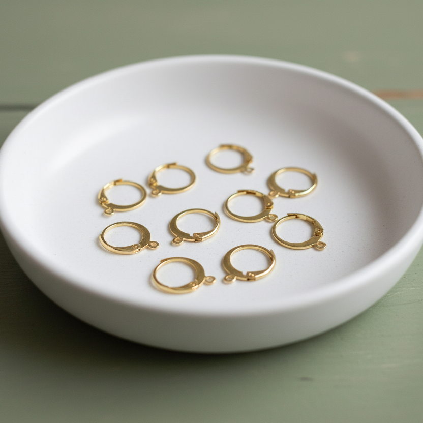 Gold rings on a white dish on a green surface