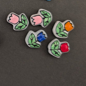 Colorful beads shaped like flowers and circles on a dark background
