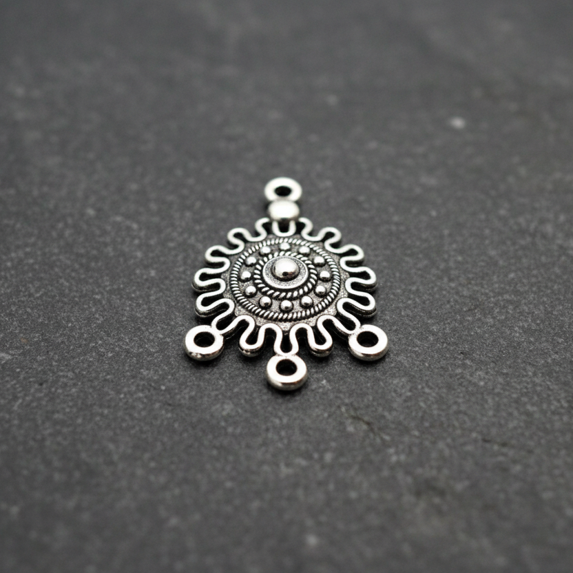 Silver decorative pendant on a black background