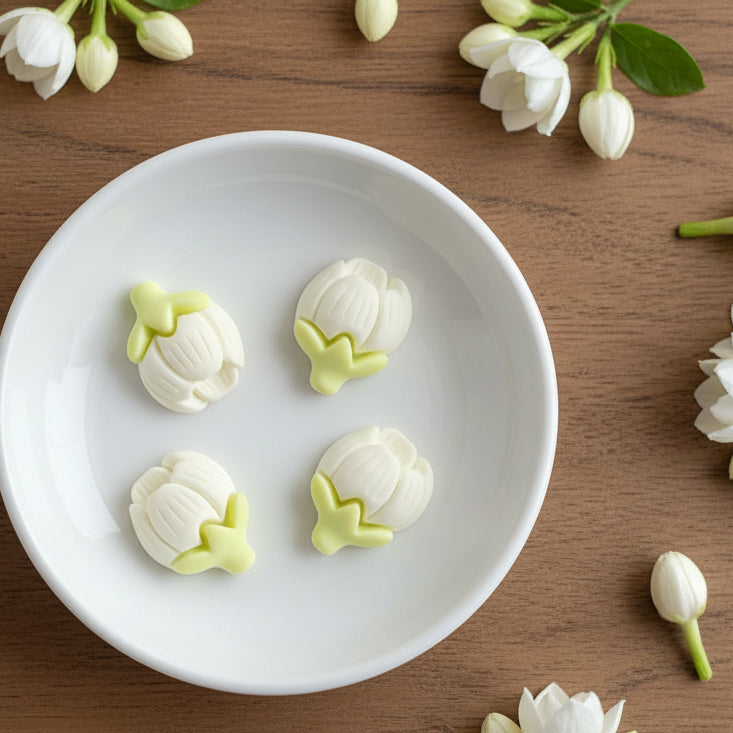 White and yellow flower-shaped buttons on a hand against a white background