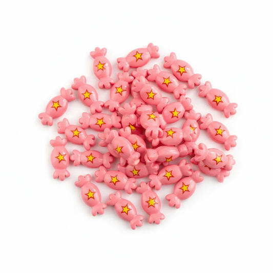 Pink candies cabochon with yellow stars on a white background
