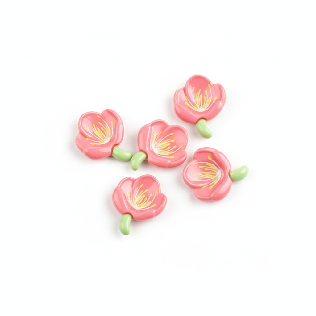 Set of pink flower-shaped cabochons with green stems on a white background