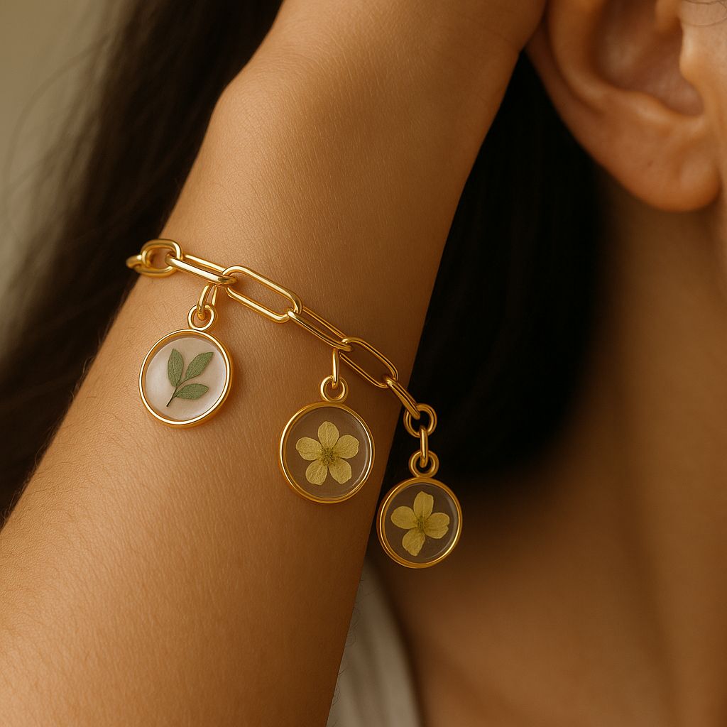 Gold bracelet with floral charms on a wrist