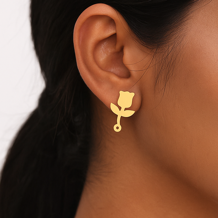 Close-up of a woman wearing a gold earring with a white background